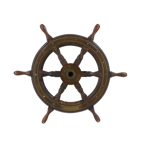 94 - A teak ship's wheel by Simpson & Lawrence - with brass binding and hub, 63cm diameter.