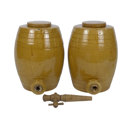 95 - A pair of treacle glazed barrels - cast with bands and a loose cover, 27cm high. (2)