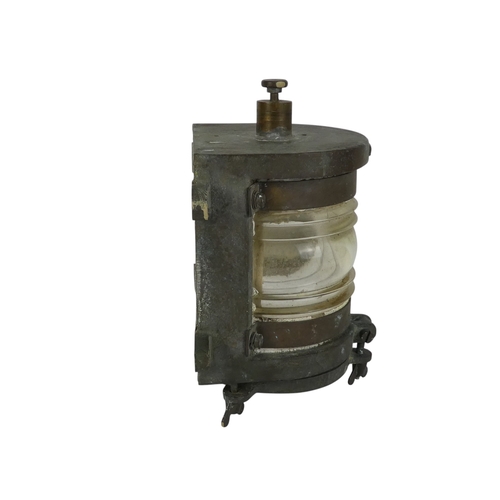 96 - An early 20th century brass mast head light - with semi-circular clear glass lens, 24cm high.