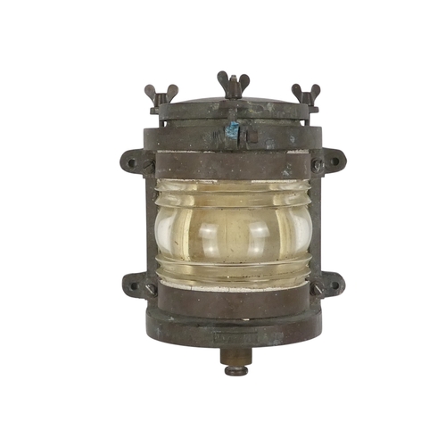 96 - An early 20th century brass mast head light - with semi-circular clear glass lens, 24cm high.