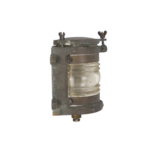 96 - An early 20th century brass mast head light - with semi-circular clear glass lens, 24cm high.