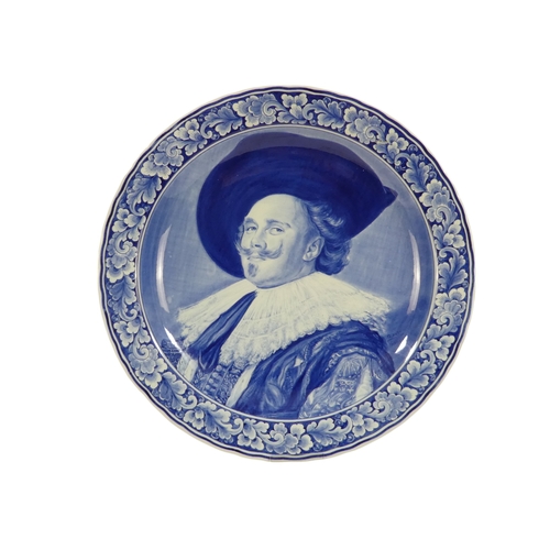 201 - A 20th century Delft charger - decorated with an image of a cavalier within a foliate border, 41cm d... 