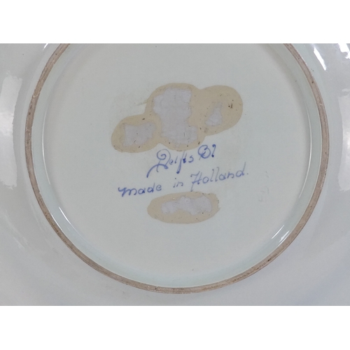 201 - A 20th century Delft charger - decorated with an image of a cavalier within a foliate border, 41cm d... 