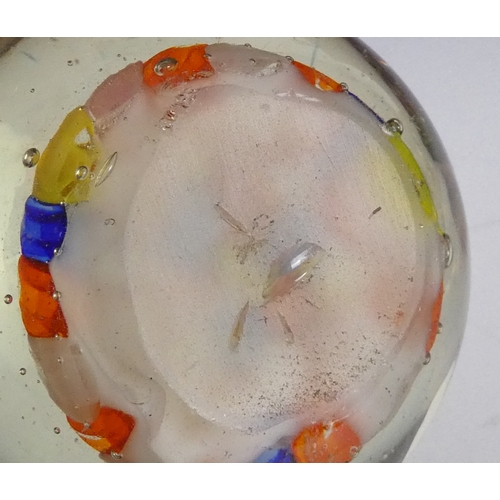 205 - A Wedgwood glass paperweight - set with an amber flower, 7cm diameter, together with four other simi... 