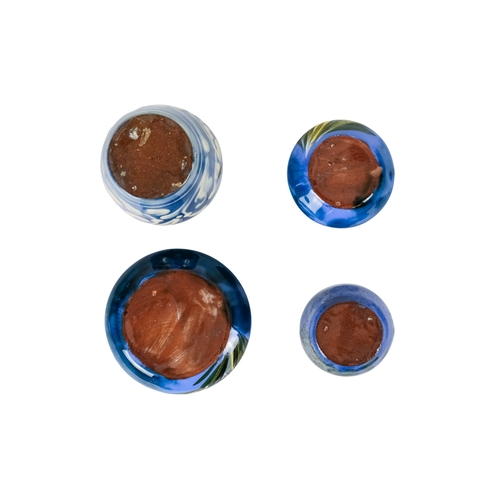 206 - A tubeline vase in the manner of Moorcroft - decorated with a leaf and flower on a pale blue ground,... 