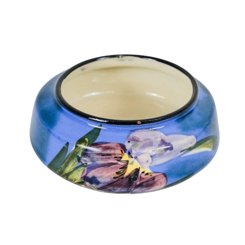 206 - A tubeline vase in the manner of Moorcroft - decorated with a leaf and flower on a pale blue ground,... 