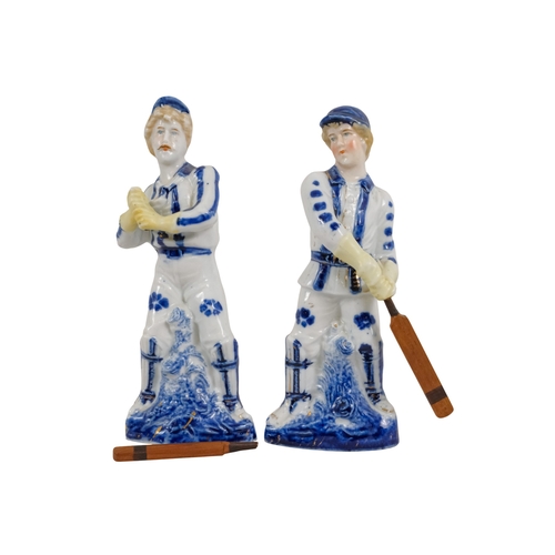 216 - A pair of early 20th century cricketing figures - each in a batting pose, 19cm high. (2)