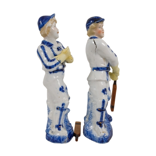 216 - A pair of early 20th century cricketing figures - each in a batting pose, 19cm high. (2)