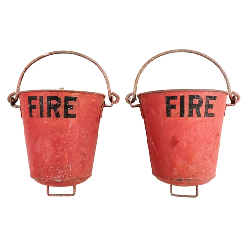 122 - A pair of red painted galvanised fire buckets - stencilled 'Fire', with swing handles and additional... 