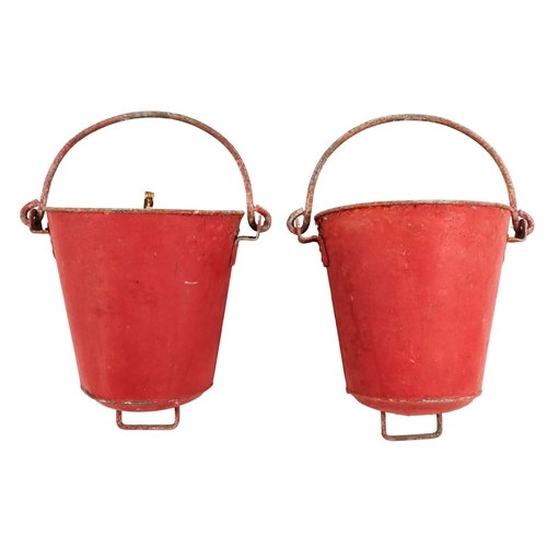 122 - A pair of red painted galvanised fire buckets - stencilled 'Fire', with swing handles and additional... 