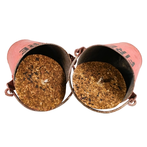 122 - A pair of red painted galvanised fire buckets - stencilled 'Fire', with swing handles and additional... 