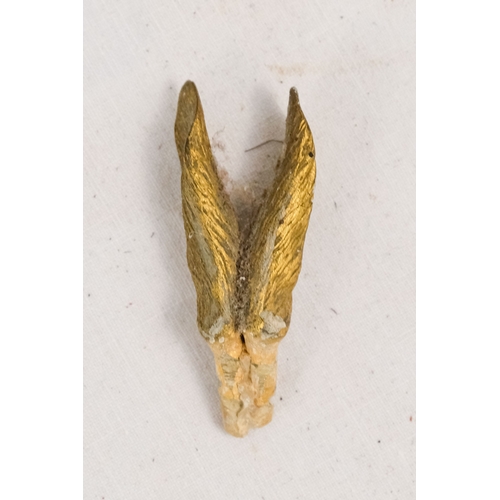 142 - An early 20th century white silk parasol - the green painted handle terminating in a carved rabbits ... 