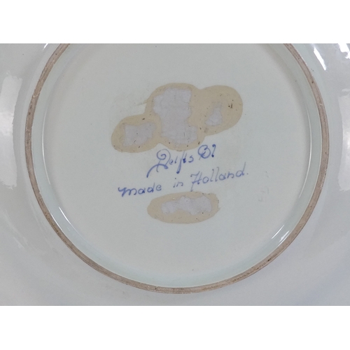 201 - A 20th century Delft charger - decorated with an image of a cavalier within a foliate border, 41cm d... 