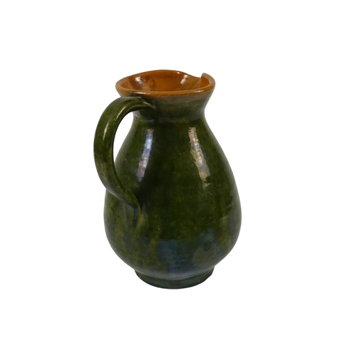 203 - A Biot Pottery style jug - with a green iridescent glaze, 21cm high.