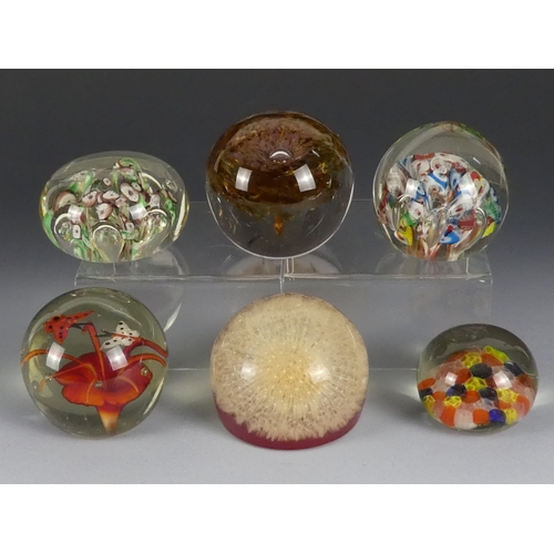 205 - A Wedgwood glass paperweight - set with an amber flower, 7cm diameter, together with four other simi... 