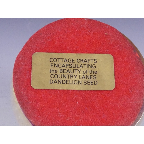 205 - A Wedgwood glass paperweight - set with an amber flower, 7cm diameter, together with four other simi... 