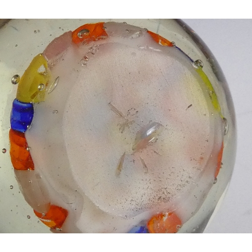 205 - A Wedgwood glass paperweight - set with an amber flower, 7cm diameter, together with four other simi... 