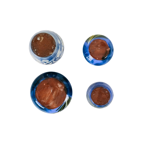 206 - A tubeline vase in the manner of Moorcroft - decorated with a leaf and flower on a pale blue ground,... 