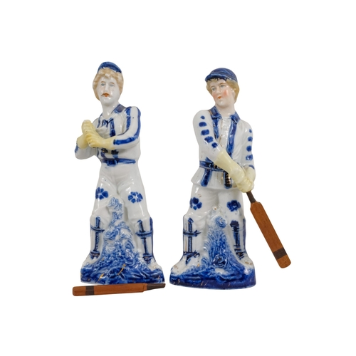 216 - A pair of early 20th century cricketing figures - each in a batting pose, 19cm high. (2)
