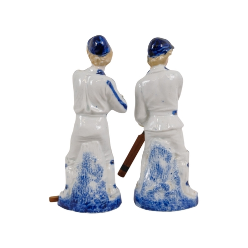 216 - A pair of early 20th century cricketing figures - each in a batting pose, 19cm high. (2)