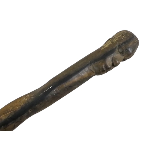 1155 - A collection of African carved hardwood figures - together with a walking cane, and four hide covere... 