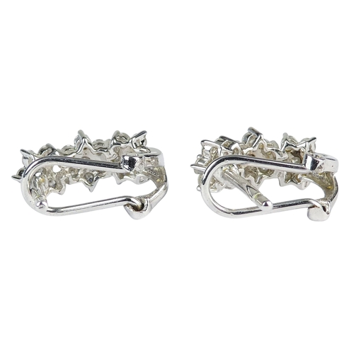 308 - A pair of white gold and diamond earrings - each with three foliate settings, one absent setting, 2.... 