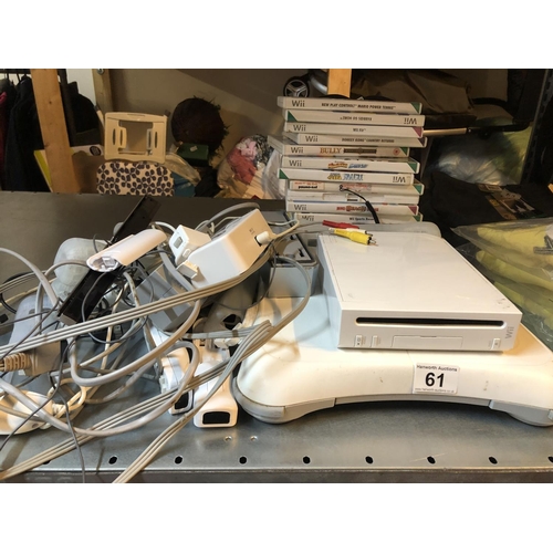 61 - Wii console, sports board, games, charger  & various controller