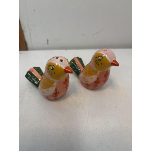 139 - Handpainted ceramic bird-shaped salt and pepper shakers with colorful designs. Approximate size and ... 