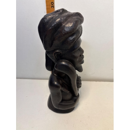 47 - Hand-carved wooden sculpture featuring a figure with detailed facial features and wrapped headgear, ... 