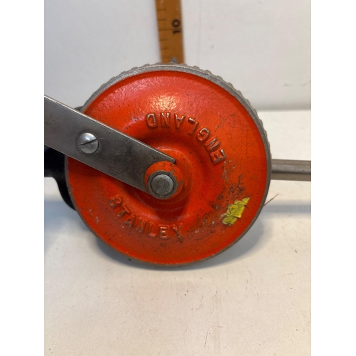 99 - Stanley hand drill made in England with red metal gear housing and wooden handle.