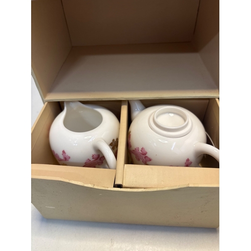 461 - Tayoha porcelain tea set including two teapots and six cups, each adorned with floral motifs, housed... 