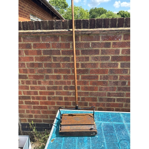 111 - Vintage wooden carpet sweeper with a metal handle, branded 'Pigur's No. 1'. Features metal hinges, m... 