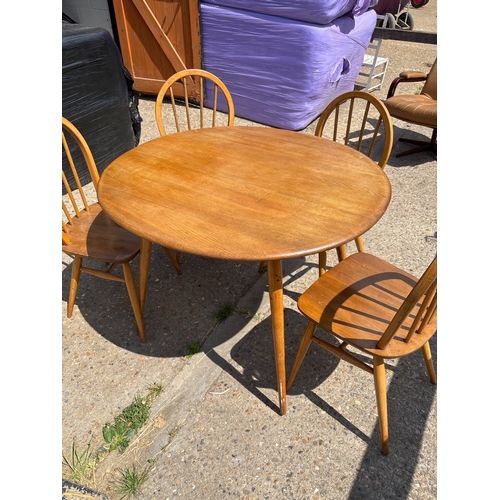 114 - Solid wood round ercol table and four matching chairs.