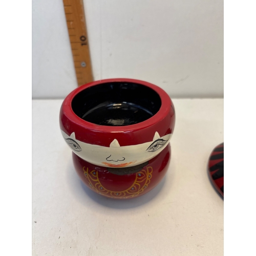 19 - Painted japanese wooden lidded container featuring a figure-like design in red, black, and white wit... 