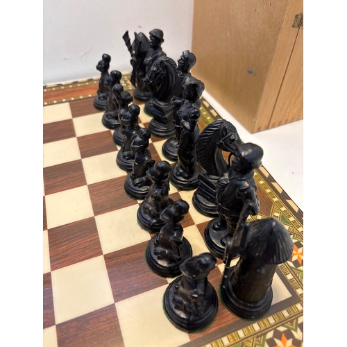 41 - chess set with detailed black and brown pieces, includes inlaid board and storage box.