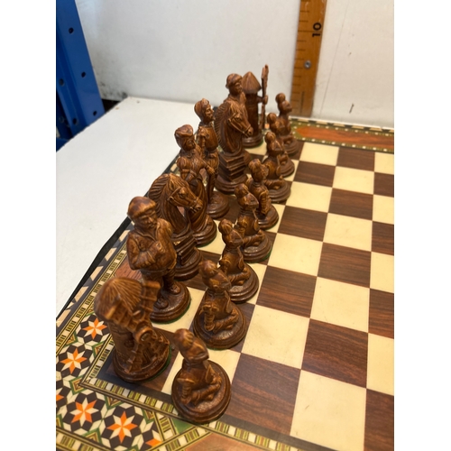41 - chess set with detailed black and brown pieces, includes inlaid board and storage box.