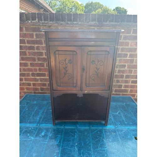 72 - Wooden cabinet with two floral-engraved doors.