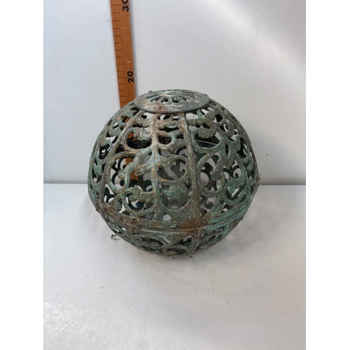 76 - Ornamental brass sphere with a patinated finish and openwork design.
