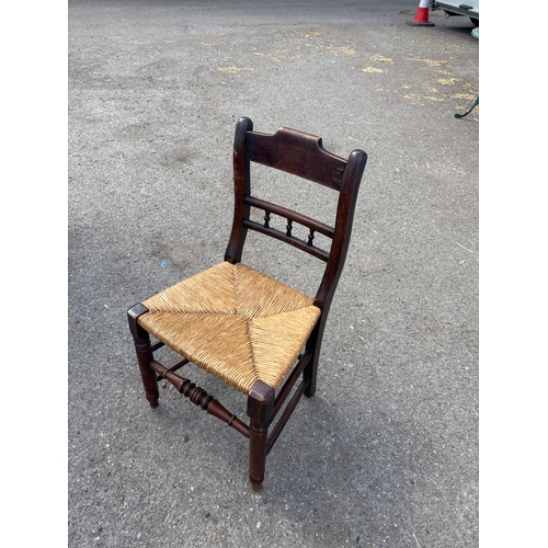 89 - Wooden chair with a woven rush seat and ladder-style back.not postable