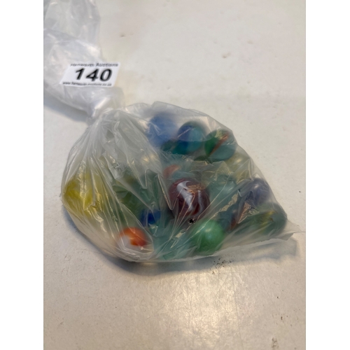 140 - Plastic bag containing assorted glass marbles.