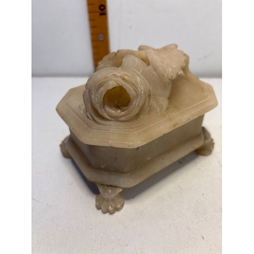 Alabaster trinket box with floral motif lid and footed base.
