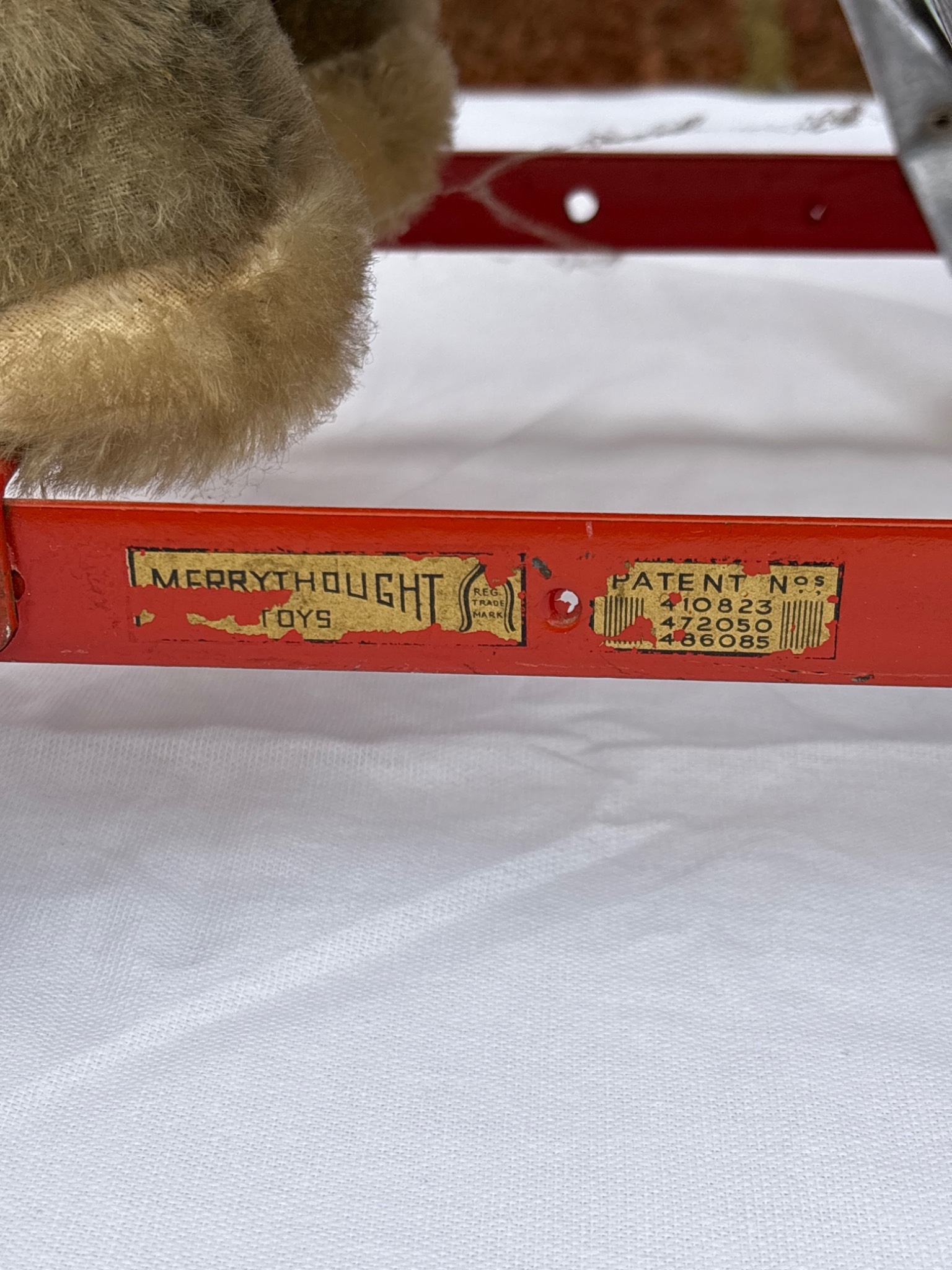 Merrythought wheeled toy elephant with red frame and yellow-striped saddle.
