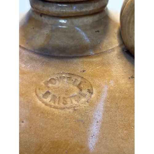 38 - Two-tone glaze stoneware jug marked 'Powell Bristol', with handle and narrow spout not postable.