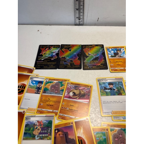 55 - Pokemon cards including energy, trainer, and holographic cards. Highlight features include cards wit... 