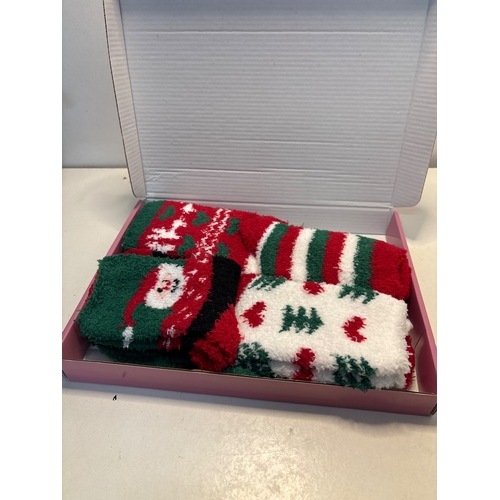 119 - Box containing multiple pairs of festive-themed socks.