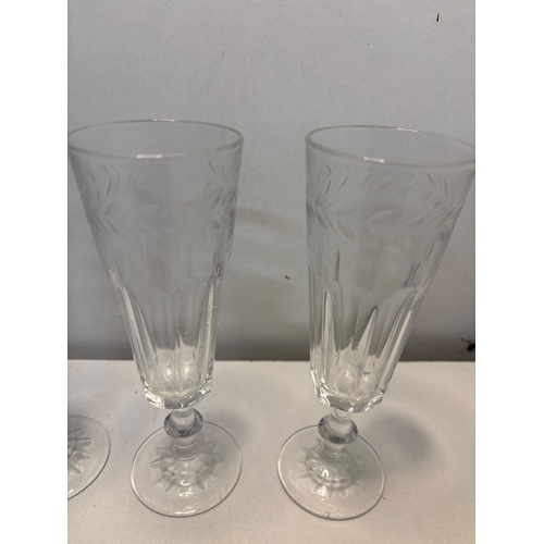 34 - Six etched crystal glasses with decorative detailing and stems. Approximately 8 inches tall.