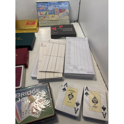 43 - Caspari playing cards and Bridge accessories including score pads, packaged card decks, and themed s... 