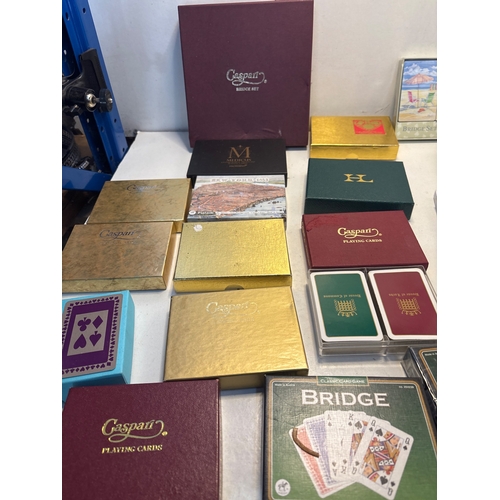 43 - Caspari playing cards and Bridge accessories including score pads, packaged card decks, and themed s... 