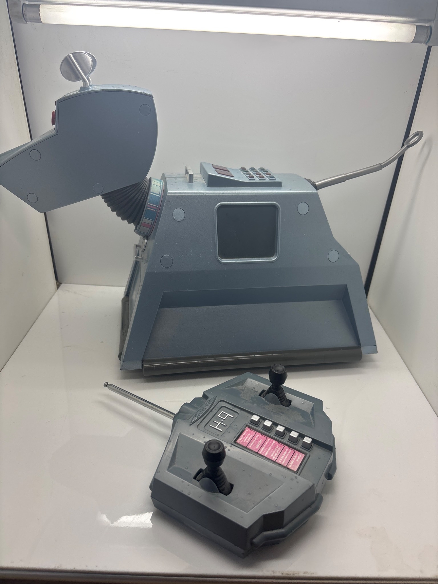 K9 Robot dog with matching remote control, gray finish.
