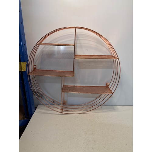 129 - Round copper metal wall shelf with multiple tiers and open grid design.